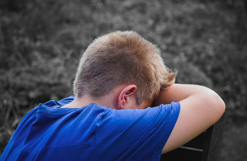 Boy sitting sad