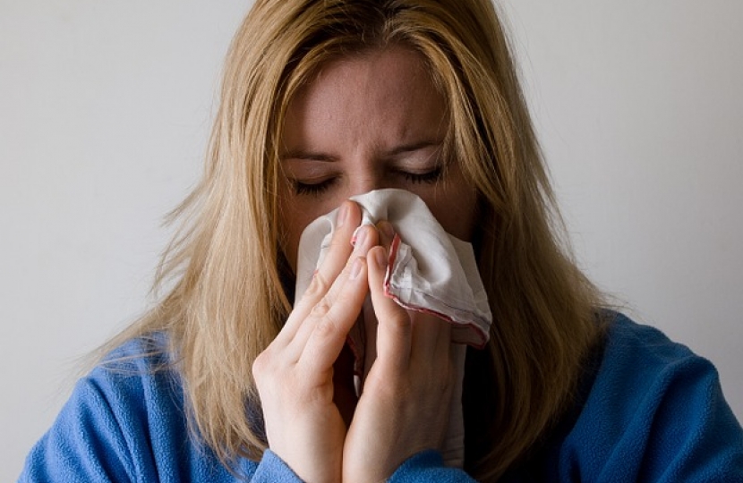 Woman blowing nose